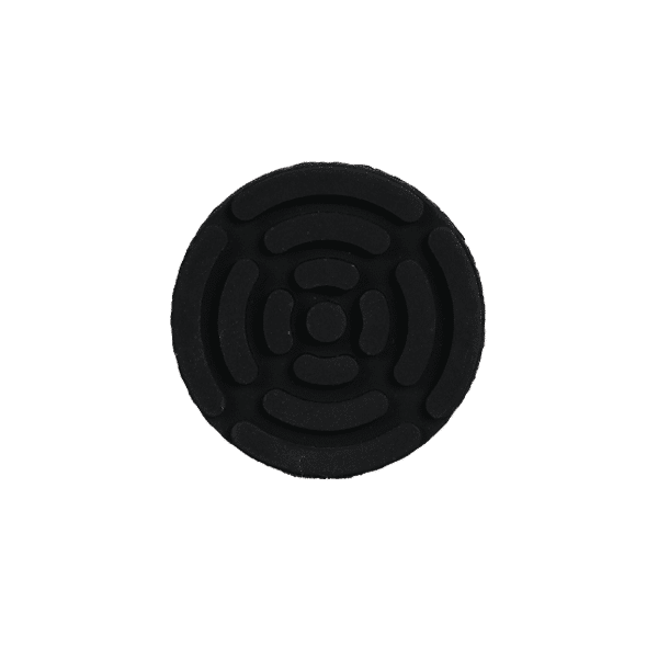 Round black rubber disk with concentric circular grooves and a small central knob-like area, a grooved grip pad