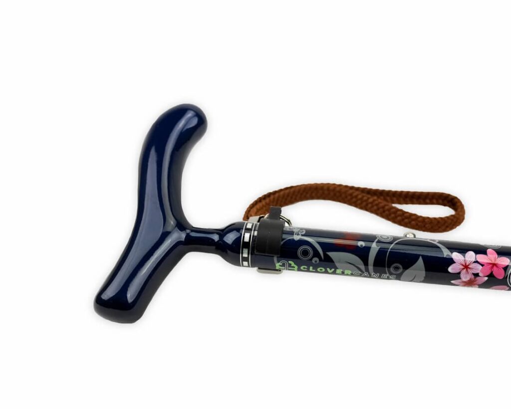 Dark blue walking cane with a T-shaped handle, brown wrist strap, and floral shaft design.
