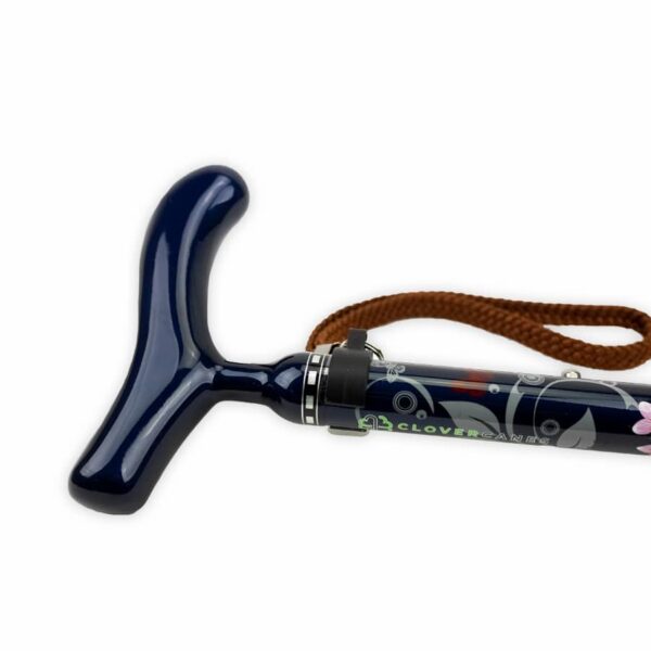 Dark blue walking cane with a T-shaped handle, brown wrist strap, and floral shaft design.