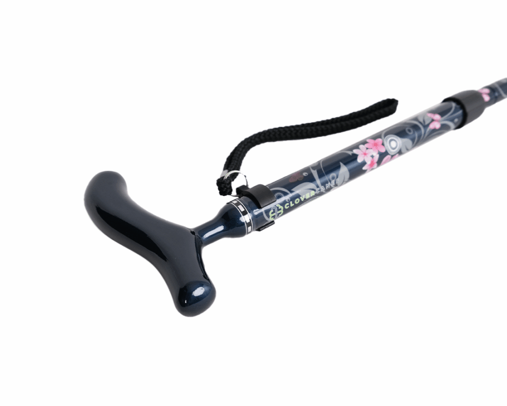 Black curved anal plug attached to a floral-patterned wand with a wrist strap on a white background.