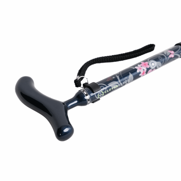 Black curved anal plug attached to a floral-patterned wand with a wrist strap on a white background.