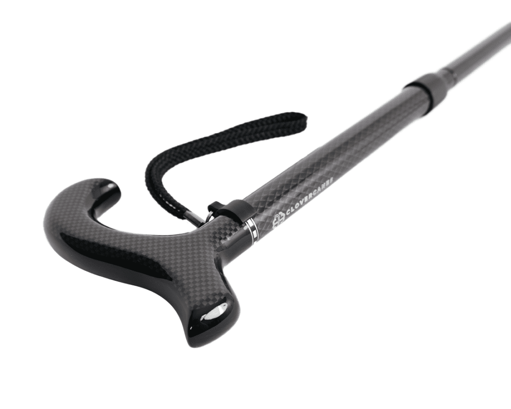 Ergonomic curved carbon-fiber trekking pole handle with a fabric wrist strap.