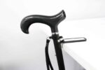 Carbon-fiber ergonomic cane handle with a textured grip and wrist strap