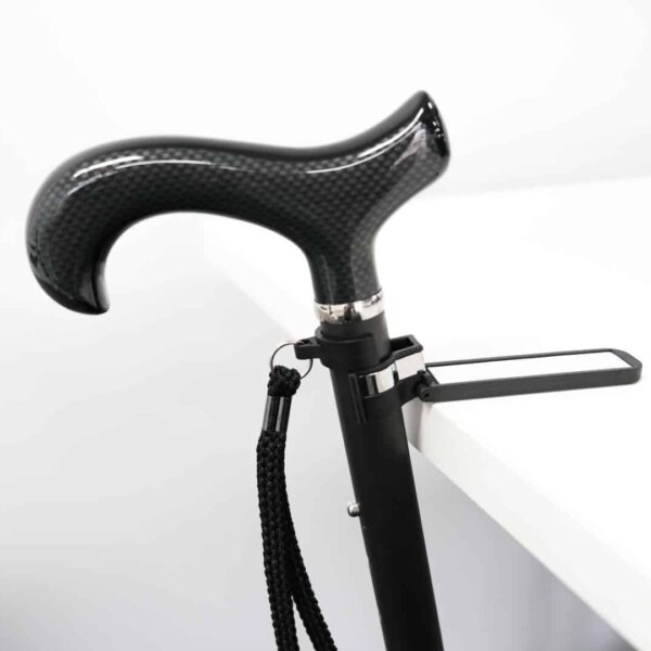 Carbon-fiber ergonomic cane handle with a textured grip and wrist strap