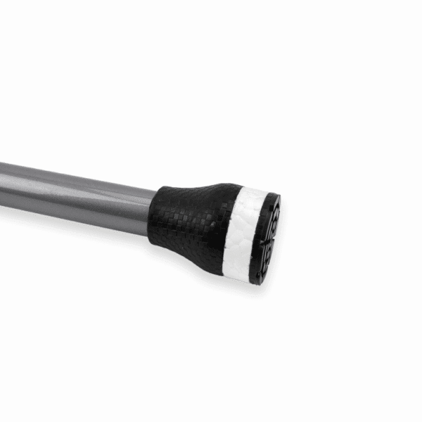 End view of a long metal rod with a black carbon-fiber grip and a white ring at its end, against a white background (likely the tip of a pole or shaft).