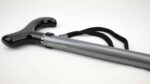 Close-up of a gray mobility cane with a glossy black handle and a black woven strap, showing the CloverCanes logo.