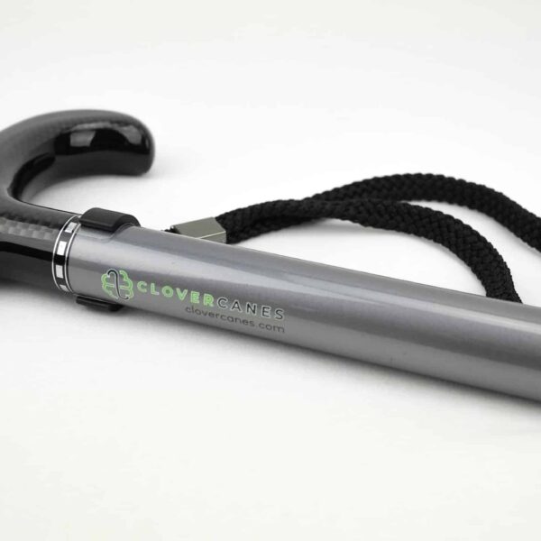 Close-up of a gray mobility cane with a glossy black handle and a black woven strap, showing the CloverCanes logo.