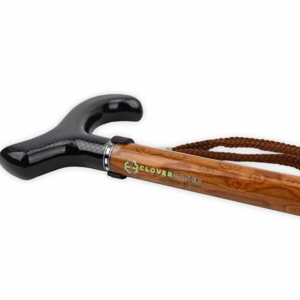 Wooden walking cane with a glossy black curved handle and a brown braided strap, Clover Canes logo visible on shaft.